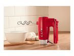 Red hand mixer with a dough hook on a kitchen counter next to a mixing bowl and eggs