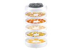 A stackable food dehydrator with multiple trays filled with various dehydrated foods.
