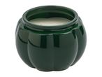 A dark green pumpkin-shaped candle in a ceramic jar with a white candle inside.