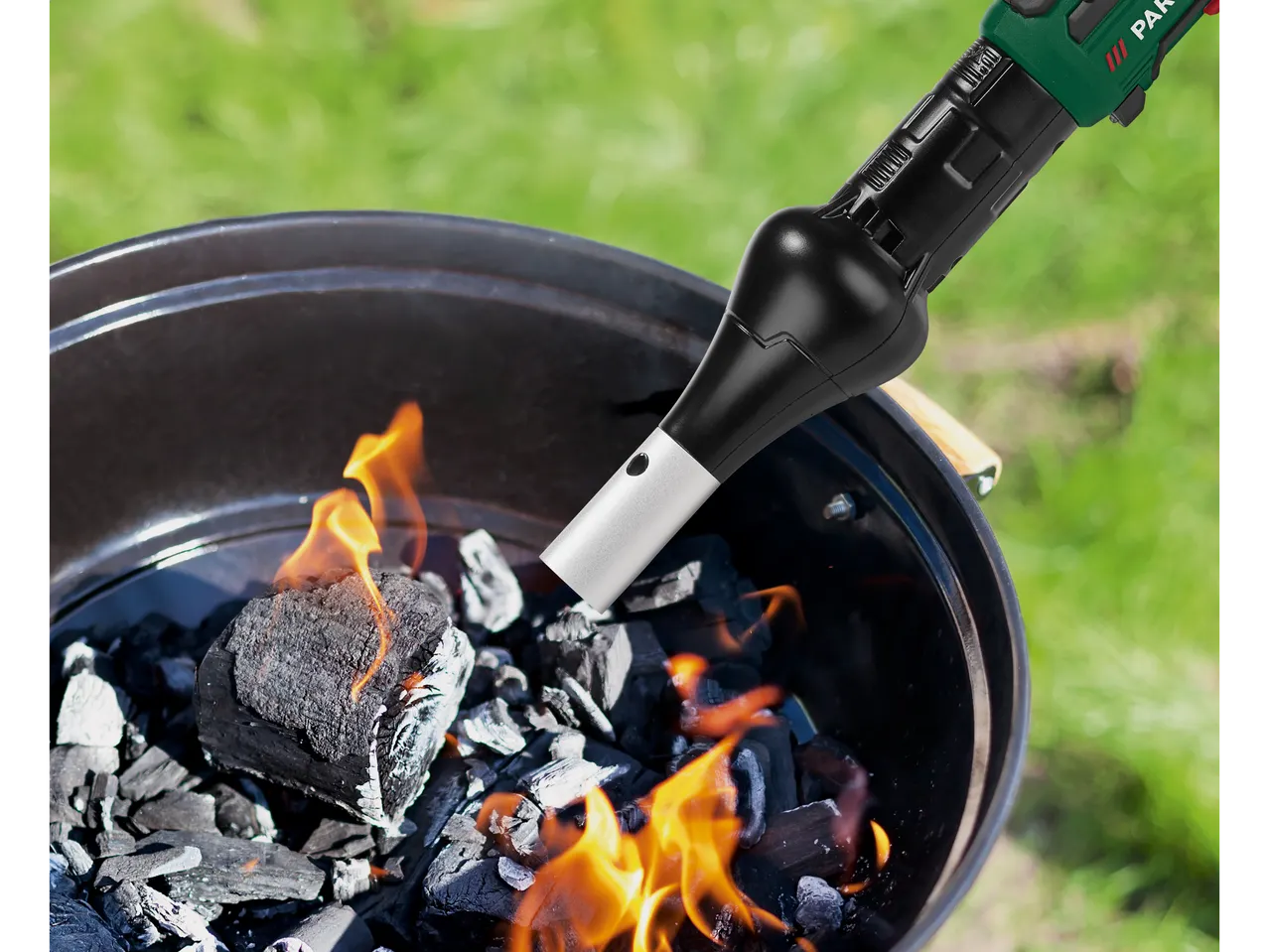 Parkside lighter and glowing coals in a barbecue.