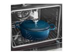 Blue enameled cast iron Dutch oven inside an oven.