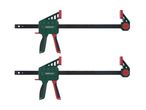 Two green and red bar clamps with black bars, used for woodworking or DIY projects.