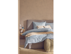 Livarno Microfibre Satin Bedlinen in light blue with a grid pattern, on a bed with a grey headboard.