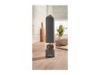A SilverCrest electric pepper grinder filled with peppercorns on a wooden kitchen counter.