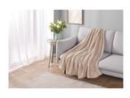 A light grey sofa with a beige throw blanket in a living room setting.