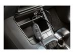 Car charger with an on/off switch and indicator light plugged into a car's console