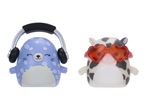 Two squishy toys: a blue seal with headphones and a cow with heart-shaped sunglasses.