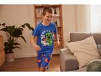 Boy wearing Minecraft pajamas runs playfully in a living room.