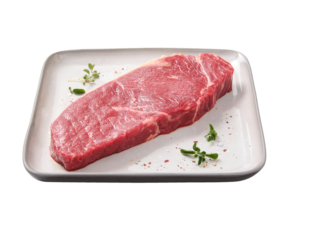 Bife Angus Rib Eye fresco com ervas e especiarias num prato branco