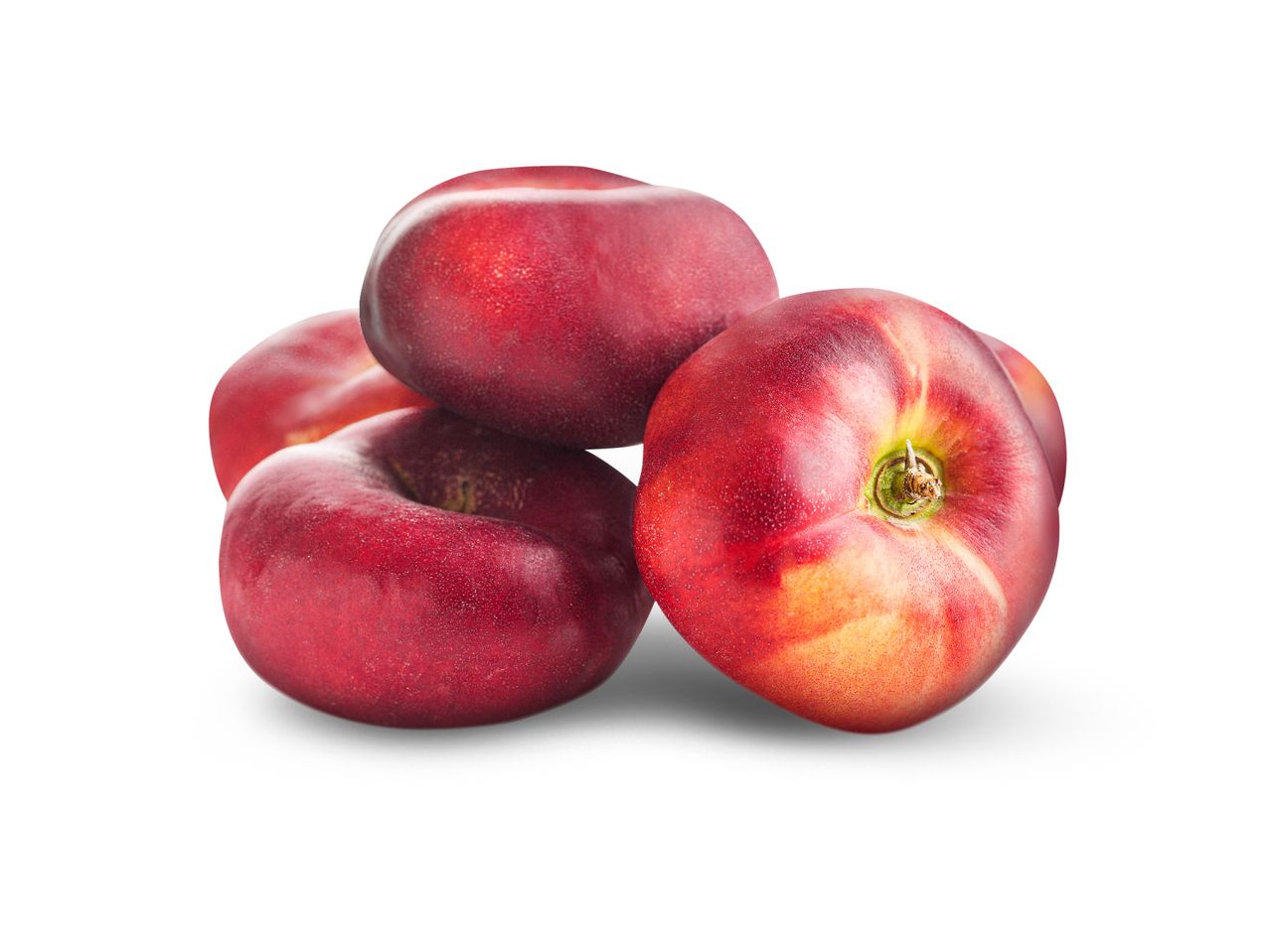 A pile of red and yellow flat peaches with a white background.