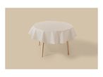 Round table with a white, translucent tablecloth on a beige background