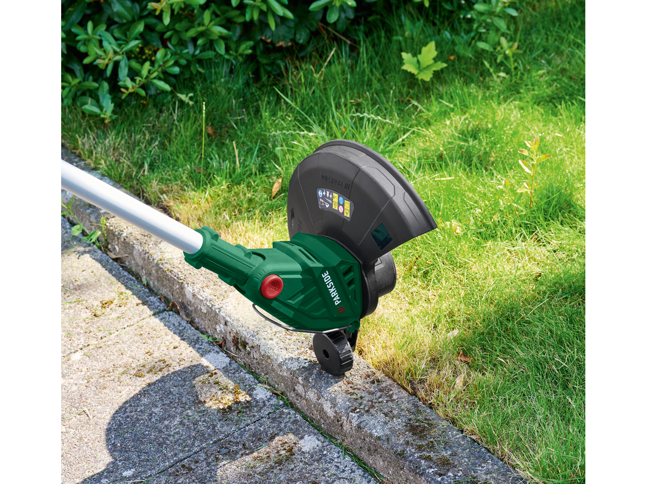 PARKSIDE® 20V Cordless Grass Trimmer edging a lawn next to a concrete path.