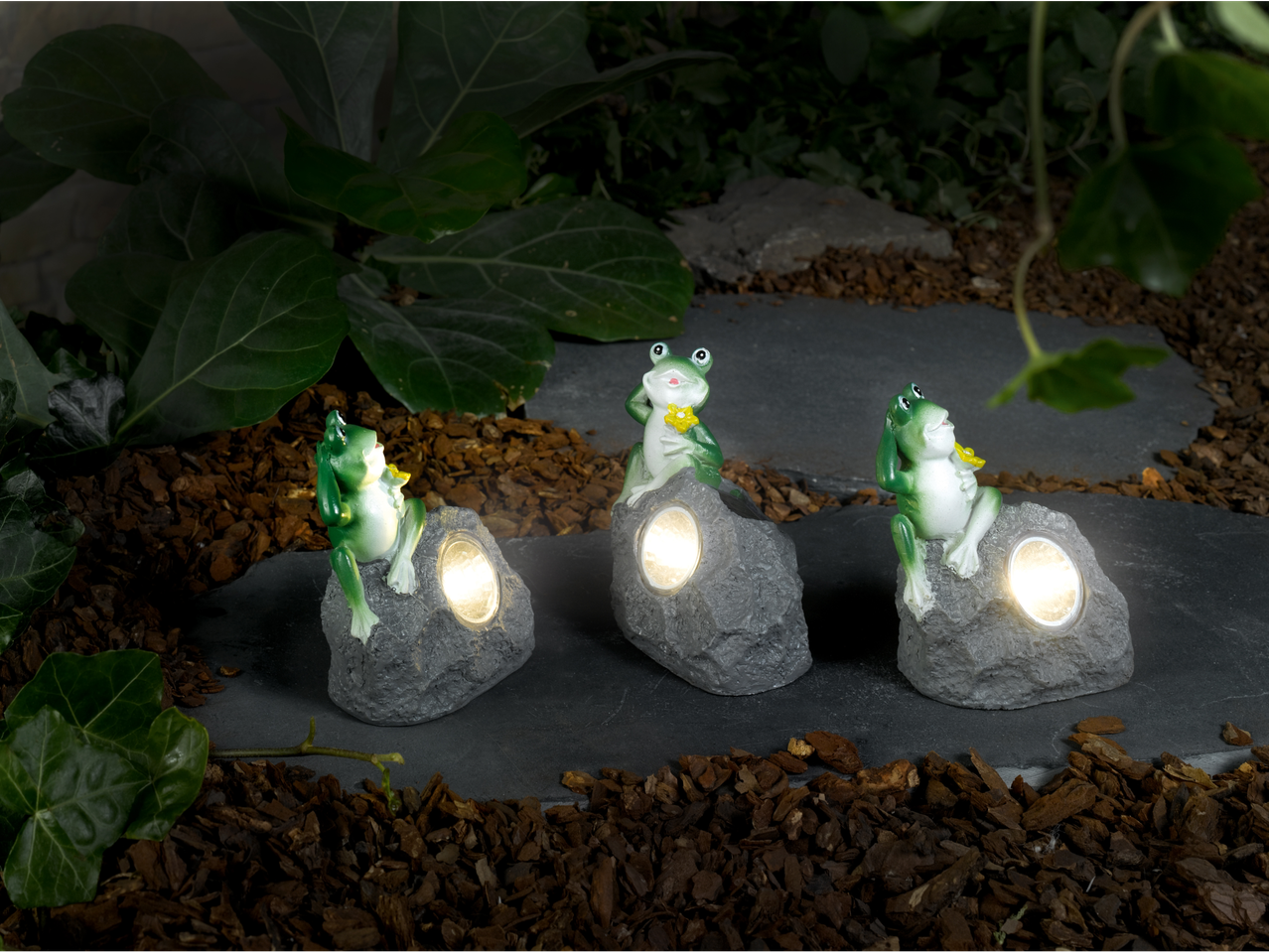Three solar garden lights featuring frog figurines.