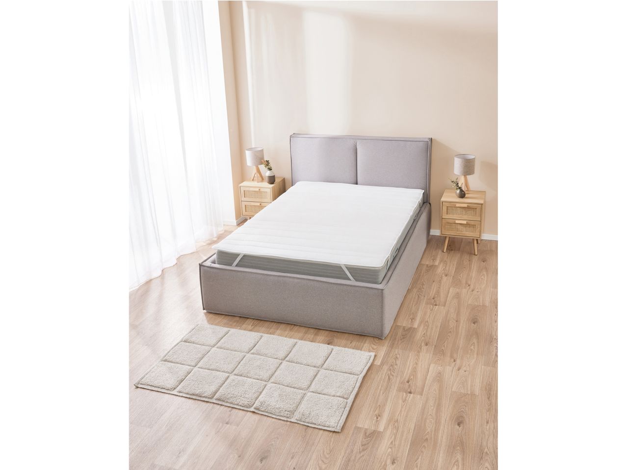 A gray platform bed with a white mattress topper.
