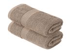 Two stacked, rolled-up beige towels