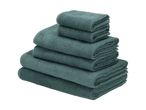 A stack of teal bath towels, neatly folded.