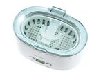 Ultrasonic cleaner with a digital display, cleaning a dental retainer in water