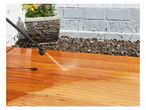 Pressure washing a wooden deck.