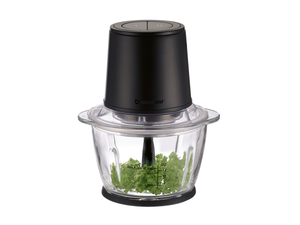 Must elektriline hakkija klaaskausiga, täidetud värske peterselliga.