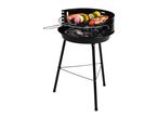 Black charcoal grill with sausage, vegetable skewers, and bacon-wrapped meat cooking on the grate.