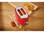 Red SILVERCREST toaster with toast and jam on a wooden table.