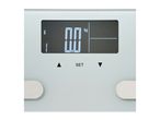 Close-up of a digital bathroom scale display showing 0.0 kg, with user profile and settings.