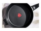 Top view of a black non-stick frying pan with a red heat indicator in the center.