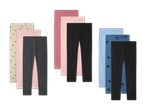 Drei Sets Kinderleggings in verschiedenen Farben und Mustern, darunter Herzen und Punkte.