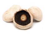 Button mushrooms: three mushrooms, one sliced.