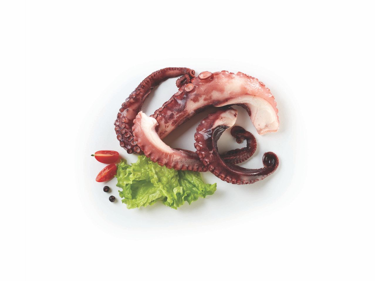 Grilled octopus tentacles served with a side of pesto.