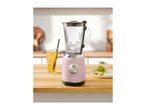 A pink SilverCrest blender with ice, a drink, and limes on a wooden kitchen counter.