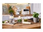 Cream-colored kitchen appliances, including a food processor, blender, and espresso machine.