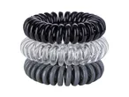 Tre elastici per capelli a spirale, neri, trasparenti e grigi.
