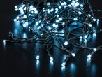 Close-up of bright blue LED string lights on a dark, reflective surface.