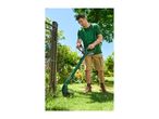 Man trimming grass with a cordless grass trimmer in a garden.