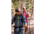 Two hikers with CRIVIT hiking backpacks and poles on a trail.