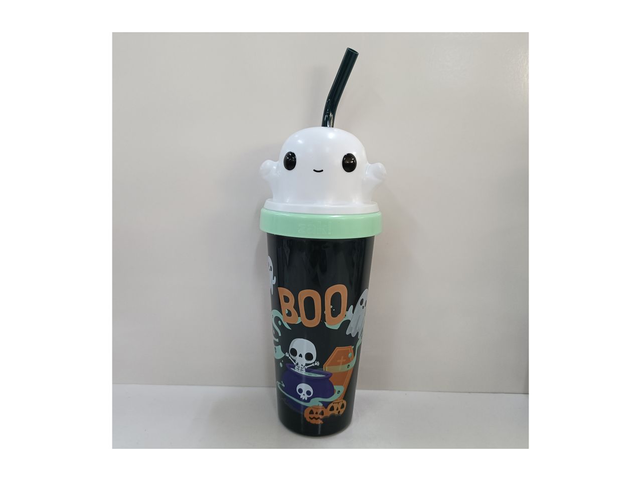 Halloween-themed tumbler with a ghost lid and 'BOO' text, featuring skeletons and pumpkins.