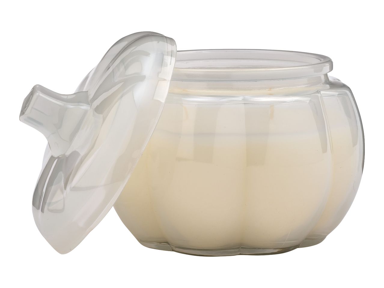A clear glass candle in a pumpkin-shaped jar with a lid, filled with light-colored wax.