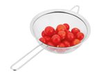 A stainless steel fine-mesh strainer holds a handful of cherry tomatoes.