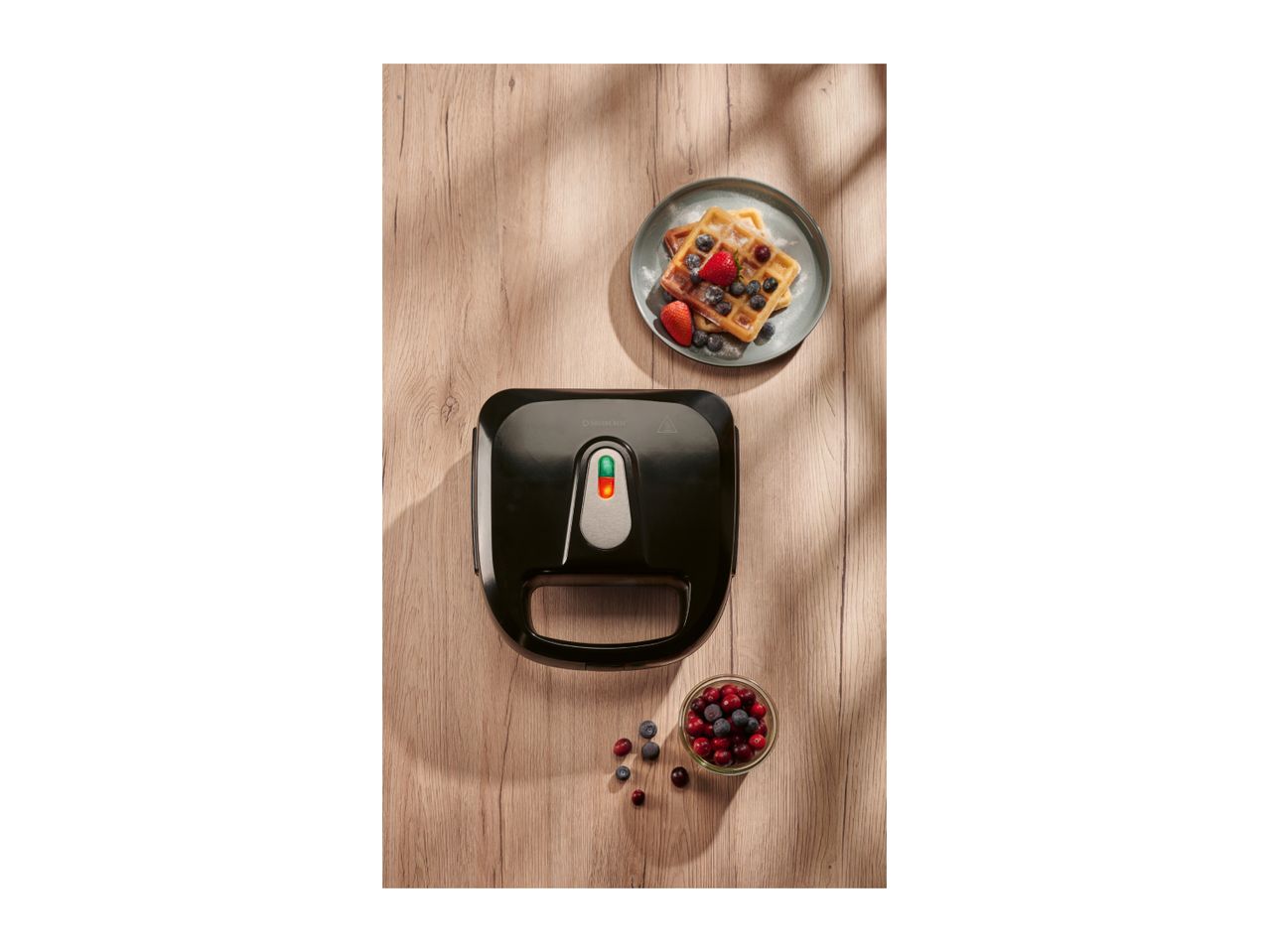 Silvercrest waffle maker with waffles and berries on a wooden table