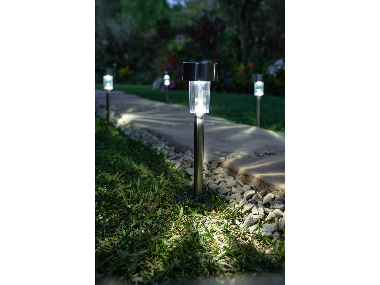LIVARNO solar garden lights illuminating a stone path at night.