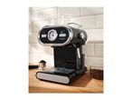 SilverCrest espresso machine with coffee beans and ground coffee on a wooden counter.