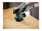 Hands in grey gloves using a Parkside orbital sander on a wooden surface.
