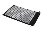 Black acupressure mat with white spikes on a white background.
