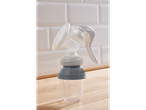 Manual breast pump and measuring cup.