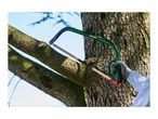 A hand in a work glove sawing a tree branch with a green bow saw.