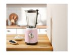 A pink SilverCrest blender on a wooden counter with blueberries and cream.