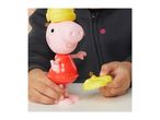 Child playing with a Peppa Pig toy, holding yellow shoes for the figure.
