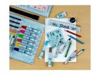 An assortment of art supplies including paints, pencils, and a ruler, neatly arranged on a table.