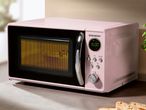 A pink SilverCrest microwave oven with a digital display showing 15:00.
